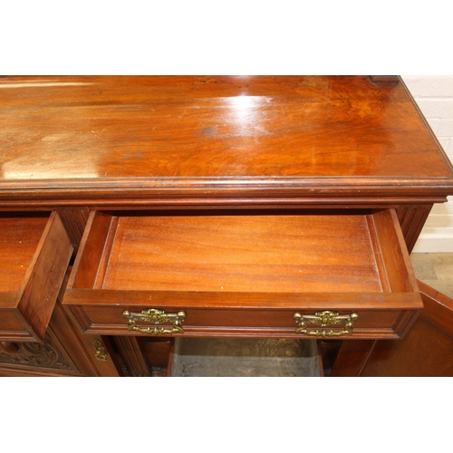 147 - Art Nouveau period mahogany sideboard with overmantel mirror, two drawers over heavily carved cupboa... 