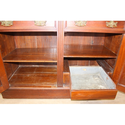 147 - Art Nouveau period mahogany sideboard with overmantel mirror, two drawers over heavily carved cupboa... 