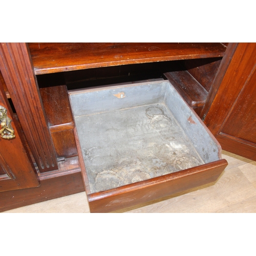 147 - Art Nouveau period mahogany sideboard with overmantel mirror, two drawers over heavily carved cupboa... 