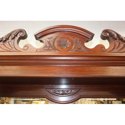147 - Art Nouveau period mahogany sideboard with overmantel mirror, two drawers over heavily carved cupboa... 
