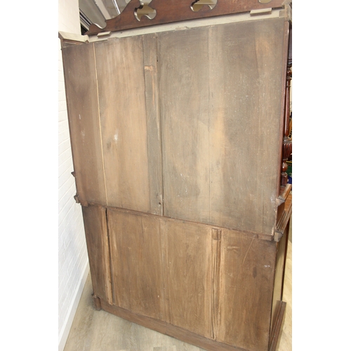 147 - Art Nouveau period mahogany sideboard with overmantel mirror, two drawers over heavily carved cupboa... 