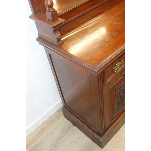 147 - Art Nouveau period mahogany sideboard with overmantel mirror, two drawers over heavily carved cupboa... 