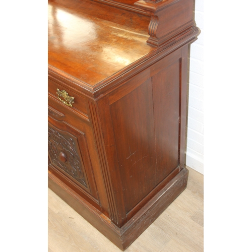 147 - Art Nouveau period mahogany sideboard with overmantel mirror, two drawers over heavily carved cupboa... 