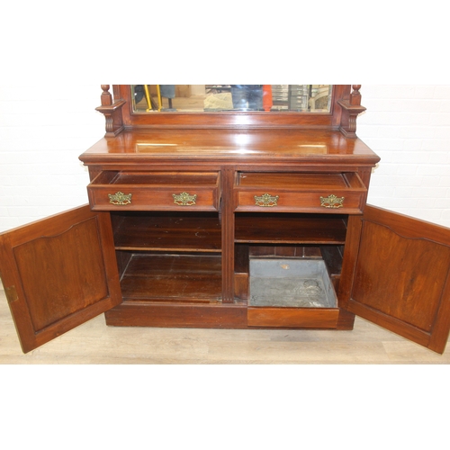 147 - Art Nouveau period mahogany sideboard with overmantel mirror, two drawers over heavily carved cupboa... 