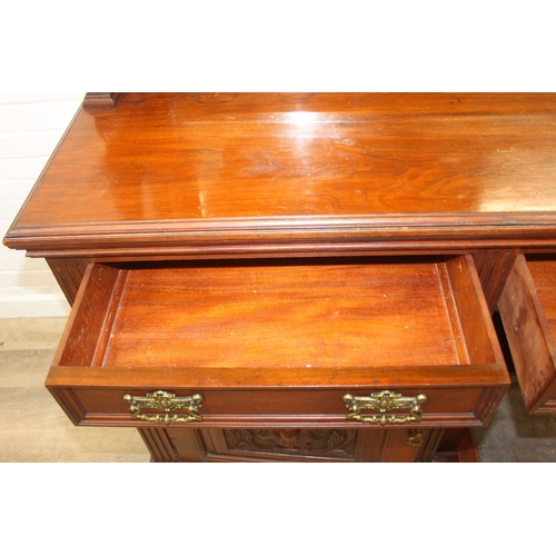 147 - Art Nouveau period mahogany sideboard with overmantel mirror, two drawers over heavily carved cupboa... 