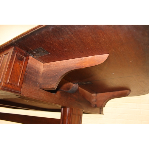 167 - A 19th century drop end mahogany sofa table with two drawers, scrolled legs with brass and ceramic c... 