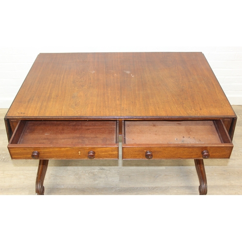 167 - A 19th century drop end mahogany sofa table with two drawers, scrolled legs with brass and ceramic c... 