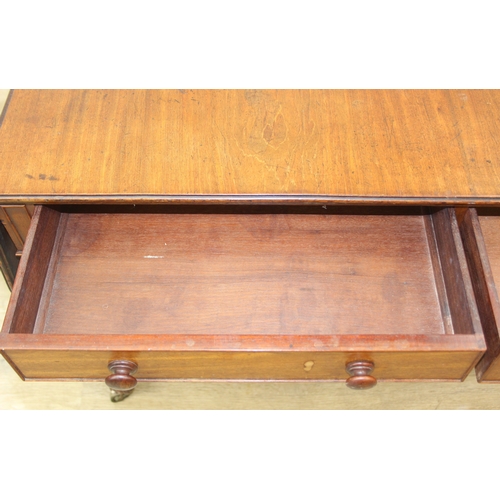 167 - A 19th century drop end mahogany sofa table with two drawers, scrolled legs with brass and ceramic c... 