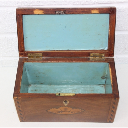 204 - A Georgian Sheraton inlaid mahogany tea caddy with inlaid shell motifs and decorative border, lackin... 