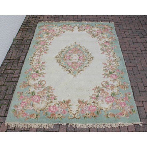 273 - A large Kashmir made super wash rug with cream ground and central medallion, 185cm x 290cm