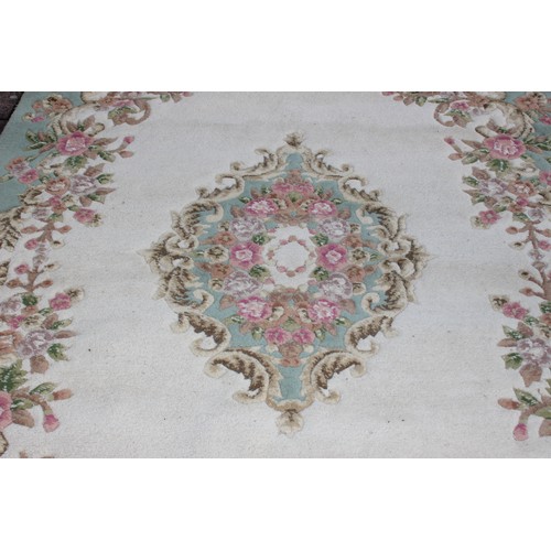 273 - A large Kashmir made super wash rug with cream ground and central medallion, 185cm x 290cm