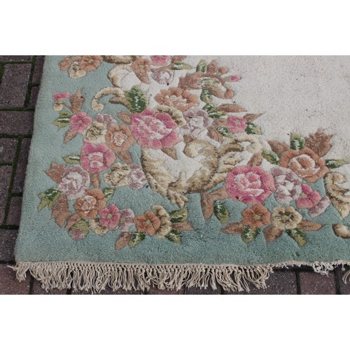 273 - A large Kashmir made super wash rug with cream ground and central medallion, 185cm x 290cm