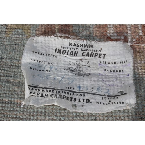 273 - A large Kashmir made super wash rug with cream ground and central medallion, 185cm x 290cm