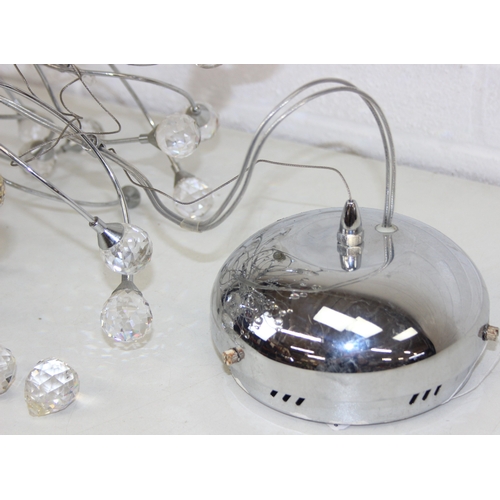 316 - A retro style pendant light with chrome twisted body mounted with crystals, 60cm in diameter