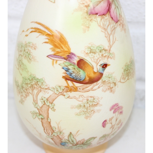 1580 - A pair of Crown Ducal vases decorated with Peacocks, each 25cm tall