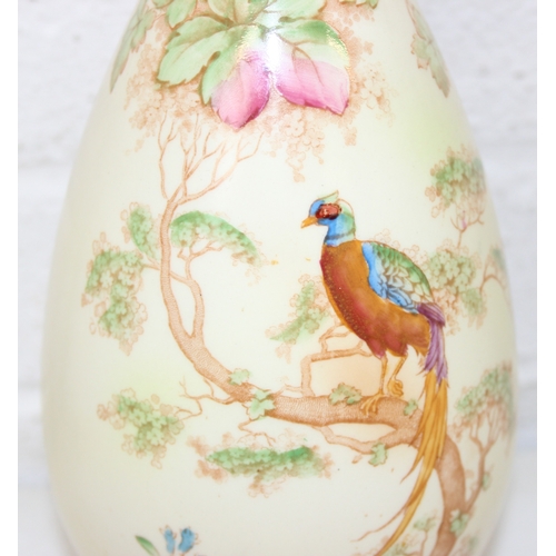 1580 - A pair of Crown Ducal vases decorated with Peacocks, each 25cm tall