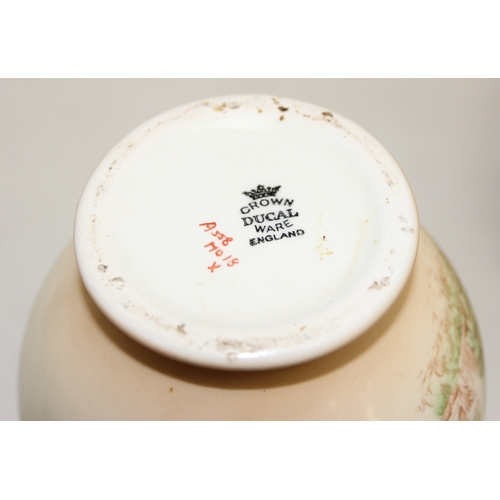 1580 - A pair of Crown Ducal vases decorated with Peacocks, each 25cm tall