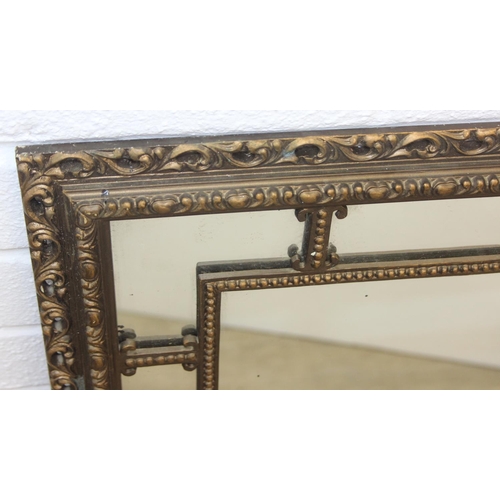 424 - A vintage decorative gilt framed wall mirror, marked 