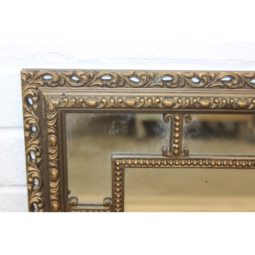 424 - A vintage decorative gilt framed wall mirror, marked 