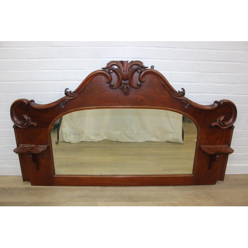 445B - Antique over mantle mirror in mahogany frame with carved details and two display shelves, 165cm x 99... 
