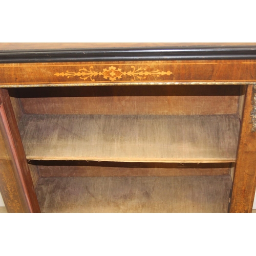 101 - A Victorian walnut and marquetry inlaid pier cabinet or glazed bookcase with gilt metal mounts, two ... 