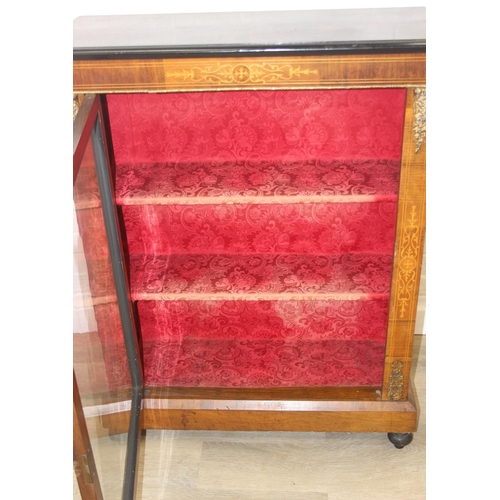 100 - A Victorian walnut and marquetry inlaid pier cabinet or glazed bookcase with gilt metal mounts, two ... 