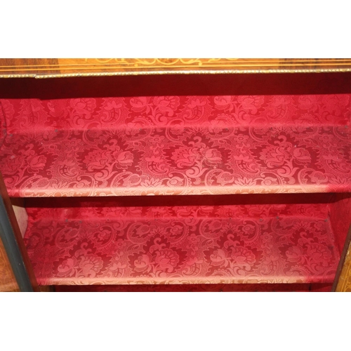 100 - A Victorian walnut and marquetry inlaid pier cabinet or glazed bookcase with gilt metal mounts, two ... 