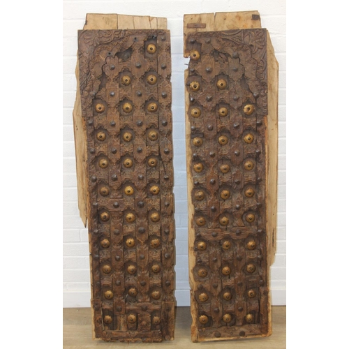 75 - A pair of antique hardwood doors with brass roundels, believed to be Indonesian and made from teak, ... 