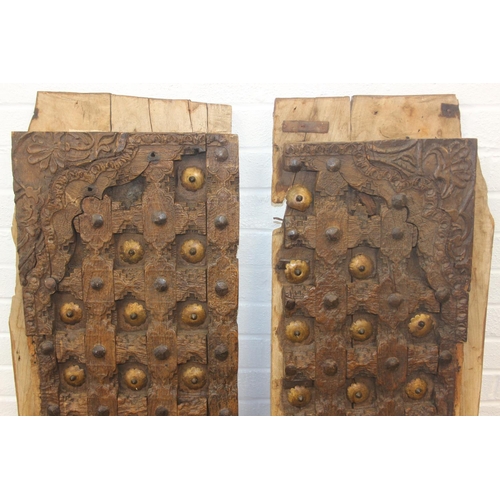 75 - A pair of antique hardwood doors with brass roundels, believed to be Indonesian and made from teak, ... 