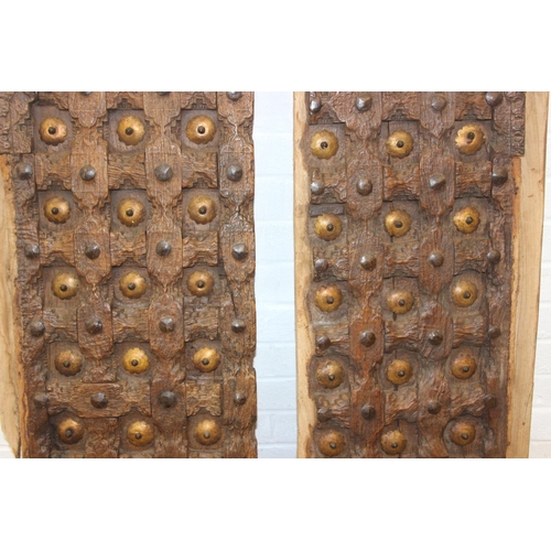 75 - A pair of antique hardwood doors with brass roundels, believed to be Indonesian and made from teak, ... 