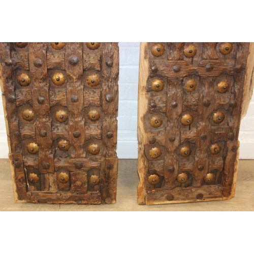 75 - A pair of antique hardwood doors with brass roundels, believed to be Indonesian and made from teak, ... 