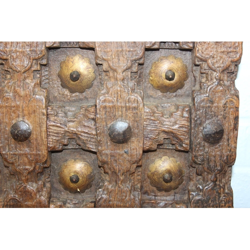 75 - A pair of antique hardwood doors with brass roundels, believed to be Indonesian and made from teak, ... 