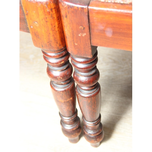 83 - A set of four Regency period mahogany dining chairs with carved back and turned legs, brown palette ... 