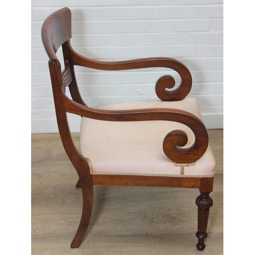 65 - An antique Regency style carved armchair with decorative scroll arms, carved back and turned and car... 