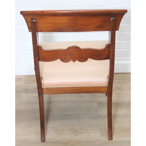 65 - An antique Regency style carved armchair with decorative scroll arms, carved back and turned and car... 