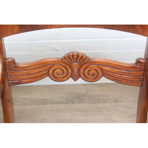 65 - An antique Regency style carved armchair with decorative scroll arms, carved back and turned and car... 