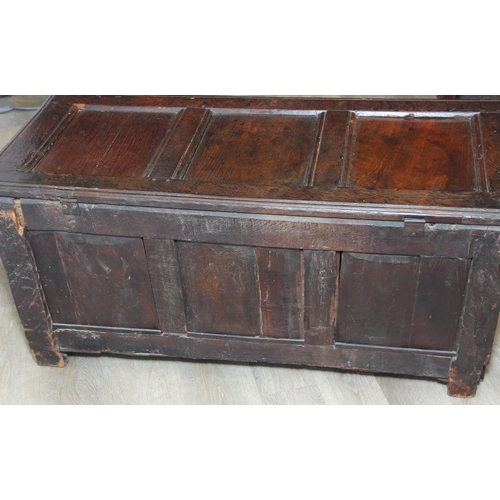89 - An 18th century oak coffer with iron fittings and panelled design, 125cm x 53cm x 57cm