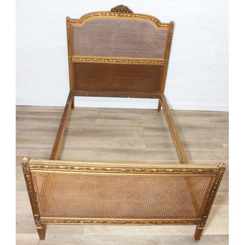 64 - A vintage single bed with gold painted carved wooden and bergère head and foot boards, side boards b... 