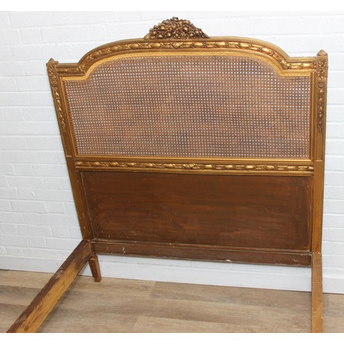 64 - A vintage single bed with gold painted carved wooden and bergère head and foot boards, side boards b... 