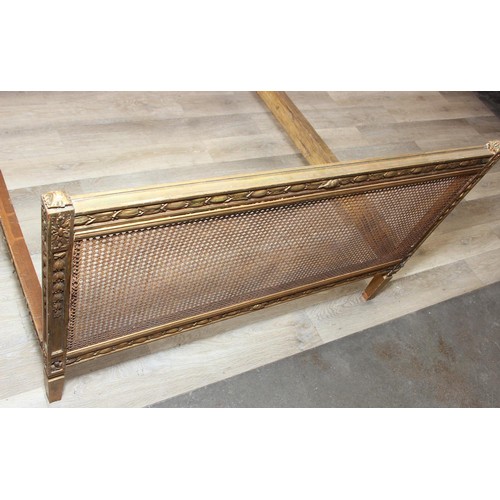64 - A vintage single bed with gold painted carved wooden and bergère head and foot boards, side boards b... 
