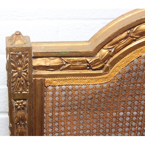 64 - A vintage single bed with gold painted carved wooden and bergère head and foot boards, side boards b... 