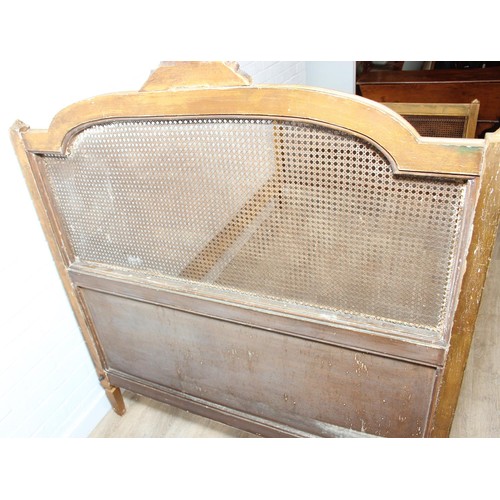 64 - A vintage single bed with gold painted carved wooden and bergère head and foot boards, side boards b... 