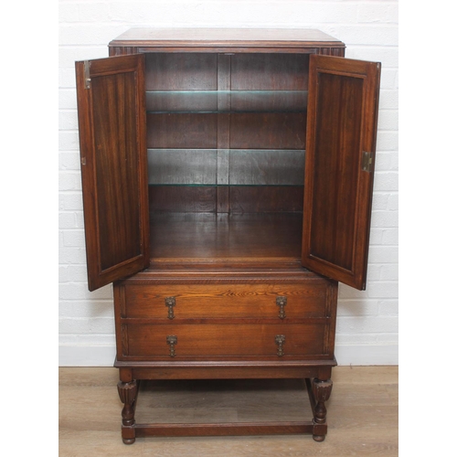 119 - Vintage oak tallboy compromising cupboard with two glass shelves over two drawers, 68cm x 44cm x 34c... 