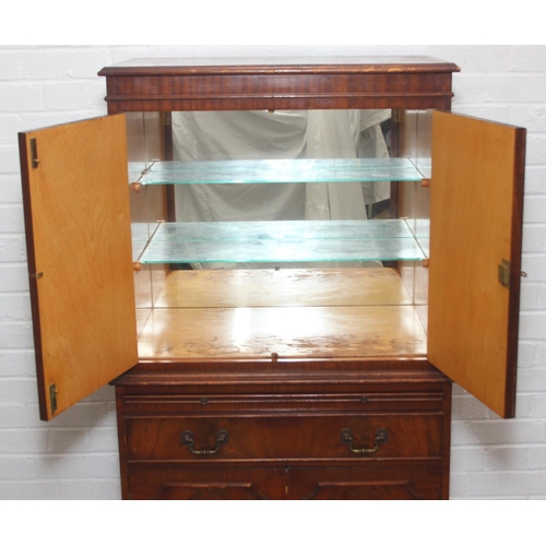 115 - Vintage mahogany cocktail cabinet with glass topped serving slide and drawer between two cupboards, ... 