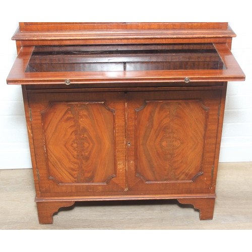 115 - Vintage mahogany cocktail cabinet with glass topped serving slide and drawer between two cupboards, ... 