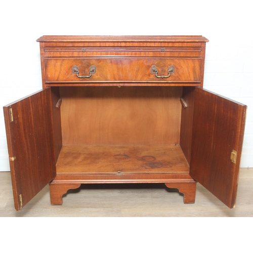 115 - Vintage mahogany cocktail cabinet with glass topped serving slide and drawer between two cupboards, ... 