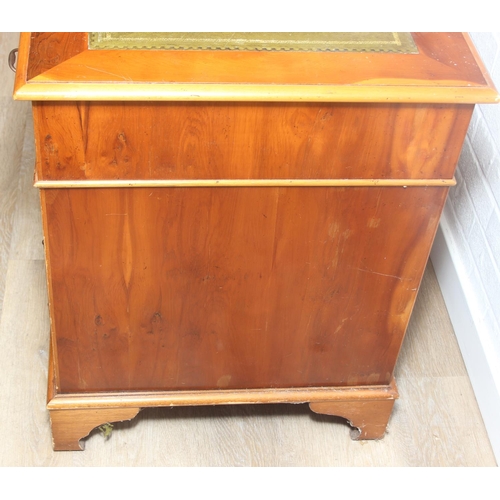 107 - A vintage Yew wood pedestal desk with inset green leather top, 120cm x 61cm x 77cm