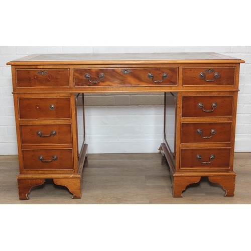 107 - A vintage Yew wood pedestal desk with inset green leather top, 120cm x 61cm x 77cm