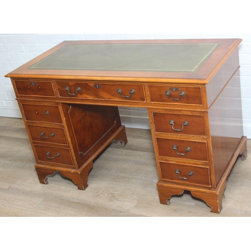 107 - A vintage Yew wood pedestal desk with inset green leather top, 120cm x 61cm x 77cm