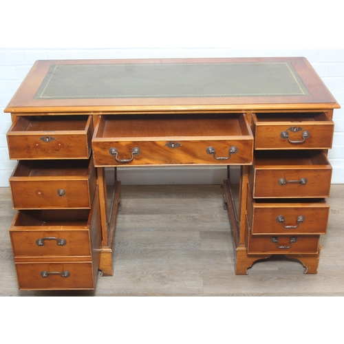 107 - A vintage Yew wood pedestal desk with inset green leather top, 120cm x 61cm x 77cm